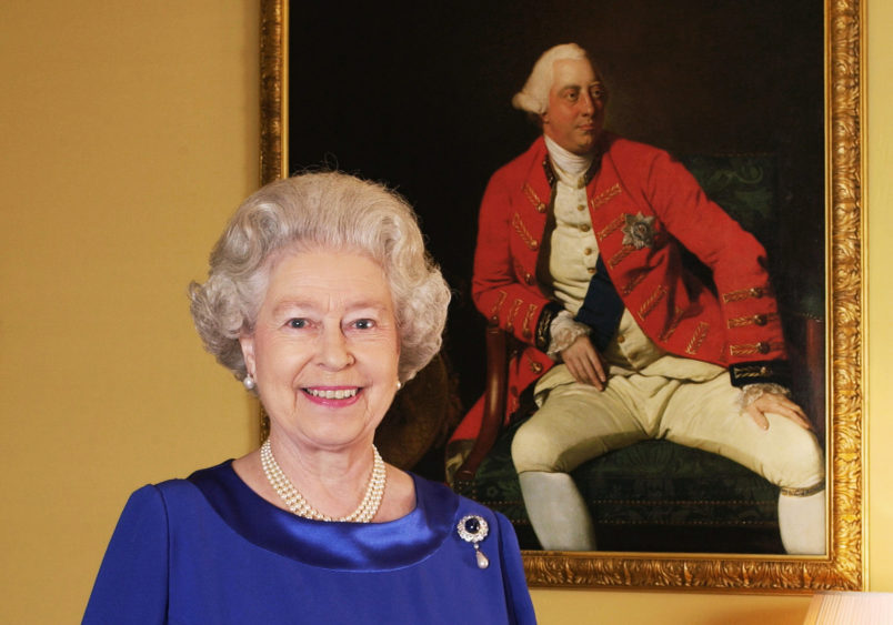 Queen Elizabeth II stands in the 18th Century Room at Buckingham Palace in front of a 1771 portrait by Johann Zoffany of George III, who was king for 59 years (1760-1820).   * This photograph is one of a Golden Jubilee portfolio of photographs being unveiled to mark the 50th anniversary of the Queen's accession. The 18th Century Room is part of the Belgian Suite, used by visiting VIPs at Buckingham Palace - the official London residence of Queen Elizabeth II. 31/05/02 Photographers including the Earl of Lichfield and the rock star Bryan Adams were gathering today to see their Golden Jubilee portraits of the Queen go on public display.Seven photographers were scheduled to attend the National Portrait Gallery n London ahead of a free exhibition to mark the monarch's 50 years on the throne.   (Photo by Fiona Hanson - PA Images/PA Images via Getty Images)