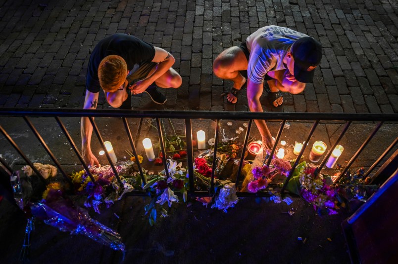 DAYTON, OH - AUGUST 5:Samuel Klug, L, and John Neff place candles around a makeshift memorial at the scene of a mass shooting in the city's historic Oregon District where Connor Betts used an "AR-15-like" rifle about 24 hours earlier to kill nine people, including his sister, and injure 27 others, on Monday, August 5, 2019, in Dayton, OH. Neff's friend is one of the 27 people injured, shot through the hand. "I've never been through something like this before," Neff said. "This is pretty painful. I don't have kids, but I would hate to be feeling what a parent is going through right now. This is awful." He added, "I don't think thoughts and prayers are going to protect us anymore. I don't think they ever have. We need some gun laws that are going to protect us, and protect our husbands and wives and kids. I think we need people in power that are going to protect our future. If we continue to let this happen, who knows if we're going to have a future." The attack came less than a day after a man with a high-powered weapon killed 20 people in El Paso, Texas, and a week after a gunman killed three people and wounded 12 at the Gilroy Garlic Festival in California. (Photo by Jahi Chikwendiu/The Washington Post).