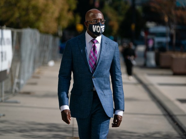 ATLANTA, GA - OCTOBER 21: Democratic U.S. senatorial candidate Raphael Warnock walks to State Farm Arena to cast his ballot on October 21, 2020 in Atlanta, Georgia. (Photo by Elijah Nouvelage/Getty Images)