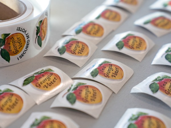 ATLANTA, GA - JANUARY 05: Stickers for voters after they have voted, sit on a table at a Cobb County voting location on January 5, 2021 in Atlanta, Georgia. Polls have opened across Georgia in the two runoff elections, pitting incumbents Sen. David Perdue (R-GA) and Sen. Kelly Loeffler (R-GA) against Democratic candidates Rev. Raphael Warnock and Jon Ossoff. (Photo by Megan Varner/Getty Images)