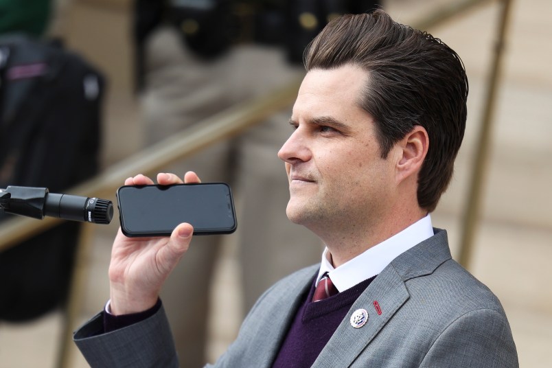 CHEYENNE, WY - JANUARY 28: Rep. Matt Gaetz (R-FL) holds a phone to the microphone as Donald Trump Jr. speaks remotely to a crowd during a rally against Rep. Liz Cheney (R-WY) on January 28, 2021 in Cheyenne, Wyoming. Gaetz and Trump Jr. added their voices to a growing effort to vote Cheney out of office after she voted in favor of impeaching Donald Trump. (Photo by Michael Ciaglo/Getty Images)