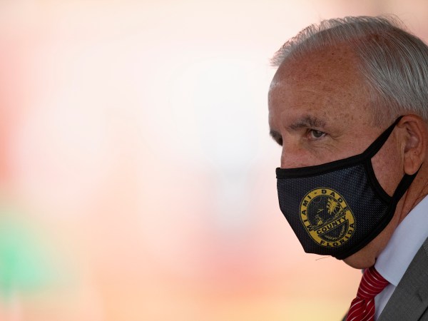 Miami-Dade County Mayor Carlos Gimenez looks on at the COVID-19 drive-thru testing center at Miami-Dade County Auditorium in Miami on Thursday, July 23, 2020. (David Santiago/Miami Herald/TNS)