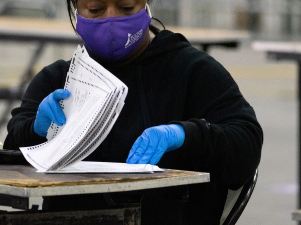 ATLANTA, GA - JANUARY 06: Election officials count the votes for Fulton County on January 6, 2021 in Atlanta, Georgia. The polls closed last night at 7pm for the runoff election for Senate Seats between Republican incumbents David Perdue, and Kelly Loeffler and Democratic candidates John Ossoff and Rev. Raphael Warnock. (Photo by Megan Varner/Getty Images)