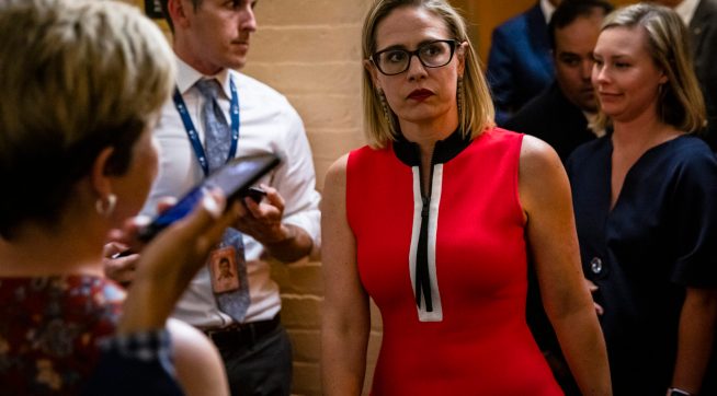 WASHINGTON, DC - JUNE 08: U.S. Sen. Kirsten Sinema (D-AZ) heads back to a bipartisan meeting on infrastructure in the basement of the U.S. Capitol building after the original talks fell through with the White House on June 8, 2021 in Washington, DC. Senate Majority Leader Chuck Schumer (D-NY) said they are now pursuing a two-path proposal that includes a new set of negotiations with a bipartisan group of senators. (Photo by Samuel Corum/Getty Images) *** Local Caption *** Kirsten Sinema