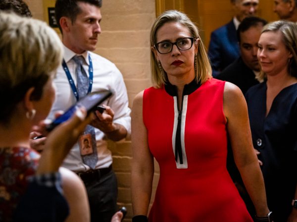 WASHINGTON, DC - JUNE 08: U.S. Sen. Kirsten Sinema (D-AZ) heads back to a bipartisan meeting on infrastructure in the basement of the U.S. Capitol building after the original talks fell through with the White House on June 8, 2021 in Washington, DC. Senate Majority Leader Chuck Schumer (D-NY) said they are now pursuing a two-path proposal that includes a new set of negotiations with a bipartisan group of senators. (Photo by Samuel Corum/Getty Images) *** Local Caption *** Kirsten Sinema