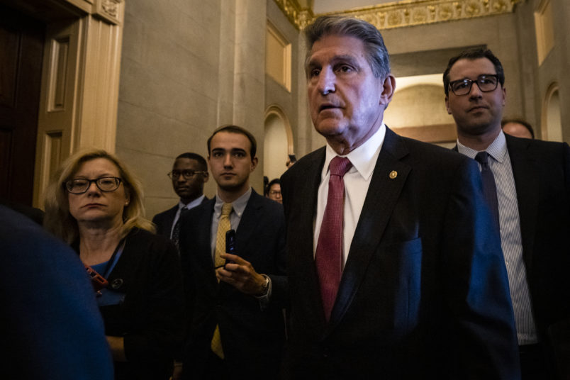 WASHINGTON, DC - JUNE 23: U.S. Sen. Joe Manchin (D-WV) is swarmed by reporters as he leaves a meeting between a bipartisan group of Senators and White House officials as they attempt to come to a deal on the Biden administrations proposed infrastructure plan at the U.S. Capitol on June 23, 2021 in Washington, DC. After initial negotiations between the White House and Senate Republicans fell through a new bi partisan group of Senators came together with the hopes of reaching a deal for a much need infrastructure spending plan. (Photo by Samuel Corum/Getty Images) *** Local Caption *** Joe Manchin