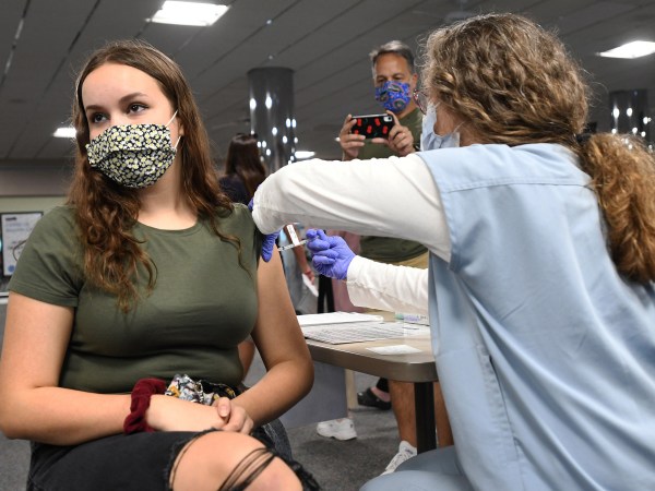 MELBOURNE, FLORIDA, UNITED STATES - 2021/05/17: A nurse gives Sherri Trimble, 15, a shot of the vaccine at a vaccination clinic at Health First Medical Centre.On May 12, 2021, the CDC approved the use of the Pfizer BioNTech vaccine in 12 through 15-year-old adolescents. Vaccinating this age group is seen as a keyway for middle and high schools to reopen fully by this fall. (Photo by Paul Hennessy/SOPA Images/LightRocket via Getty Images)