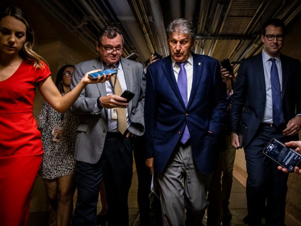 WASHINGTON, DC - JULY 26: U.S. Sen. Joe Manchin (D-WV) is followed by a swarm of reporters as he leaves a meeting between a group of bipartisan Senators in the basement of the U.S. Capitol Building on July 26, 2021 in Washington, DC. The group of Senators are trying to come to an agreement on the Infrastructure Bill before Congress heads into their August recess after the initial agreement fell apart. (Photo by Samuel Corum/Getty Images) *** Local Caption *** Joe Manchin