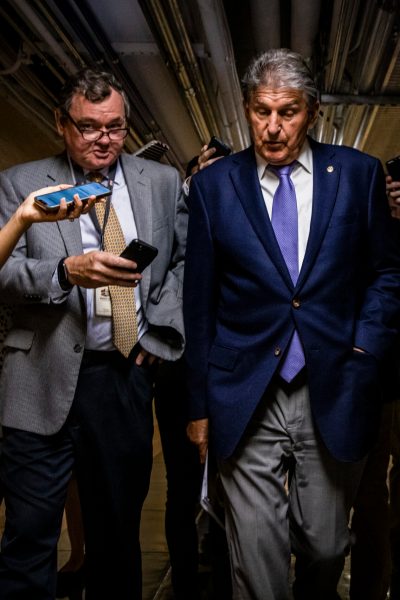 WASHINGTON, DC - JULY 26: U.S. Sen. Joe Manchin (D-WV) is followed by a swarm of reporters as he leaves a meeting between a group of bipartisan Senators in the basement of the U.S. Capitol Building on July 26, 2021 in Washington, DC. The group of Senators are trying to come to an agreement on the Infrastructure Bill before Congress heads into their August recess after the initial agreement fell apart. (Photo by Samuel Corum/Getty Images) *** Local Caption *** Joe Manchin