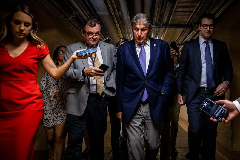 WASHINGTON, DC - JULY 26: U.S. Sen. Joe Manchin (D-WV) is followed by a swarm of reporters as he leaves a meeting between a group of bipartisan Senators in the basement of the U.S. Capitol Building on July 26, 2021 in Washington, DC. The group of Senators are trying to come to an agreement on the Infrastructure Bill before Congress heads into their August recess after the initial agreement fell apart. (Photo by Samuel Corum/Getty Images) *** Local Caption *** Joe Manchin