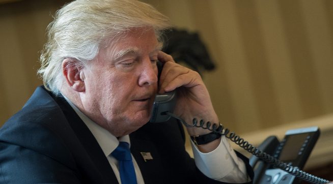 WASHINGTON, DC - JANUARY 28: President Donald Trump speaks on the phone with Russian President Vladimir Putin in the Oval Office of the White House, January 28, 2017 in Washington, DC. On Saturday, President Trump is making several phone calls with world leaders from Japan, Germany, Russia, France and Australia. (Photo by Drew Angerer/Getty Images)