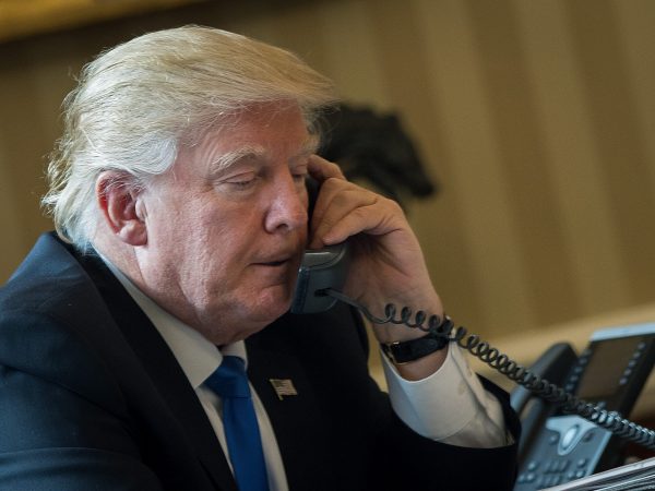 WASHINGTON, DC - JANUARY 28: President Donald Trump speaks on the phone with Russian President Vladimir Putin in the Oval Office of the White House, January 28, 2017 in Washington, DC. On Saturday, President Trump is making several phone calls with world leaders from Japan, Germany, Russia, France and Australia. (Photo by Drew Angerer/Getty Images)