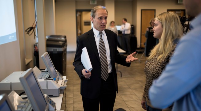 MINNEAPOLIS, MN - OCTOBER 23: Minnesota Secretary of State Steve Simon (L) speaks with city clerk Melissa Kennedy (C) and election specialist Robert Stokka (R) during a public accuracy testing of Election Day voting machines at the Municipal Services Center on October 23, 2018 in St. Louis Park, Minnesota. Each jurisdiction that operates electronic voting equipment must hold a public accuracy test within 14 days of the election (Photo by Stephen Maturen/Getty Images)