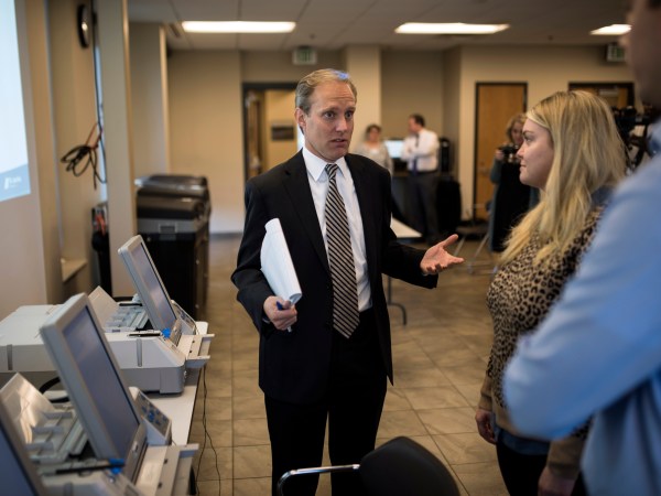 MINNEAPOLIS, MN - OCTOBER 23: Minnesota Secretary of State Steve Simon (L) speaks with city clerk Melissa Kennedy (C) and election specialist Robert Stokka (R) during a public accuracy testing of Election Day voting machines at the Municipal Services Center on October 23, 2018 in St. Louis Park, Minnesota. Each jurisdiction that operates electronic voting equipment must hold a public accuracy test within 14 days of the election (Photo by Stephen Maturen/Getty Images)