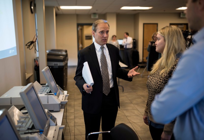 MINNEAPOLIS, MN - OCTOBER 23: Minnesota Secretary of State Steve Simon (L) speaks with city clerk Melissa Kennedy (C) and election specialist Robert Stokka (R) during a public accuracy testing of Election Day voting machines at the Municipal Services Center on October 23, 2018 in St. Louis Park, Minnesota. Each jurisdiction that operates electronic voting equipment must hold a public accuracy test within 14 days of the election (Photo by Stephen Maturen/Getty Images)