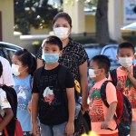 ORLANDO, FLORIDA, UNITED STATES - 2021/08/10: Students wearing face masks arrive on the first day of classes for the 2021-22 school year at Baldwin Park Elementary School. Due to the current surge in COVID-19 cases in Florida, Orange County public schools have implemented a face mask mandate for students for 30 days unless a parent chooses to opt out of the requirement. (Photo by Paul Hennessy/SOPA Images/LightRocket via Getty Images)