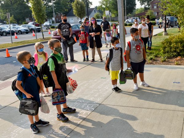 Students and parents wait outside Perry Elementary School on the first day of school. At Perry Elementary School in Shoemakersville, PA Thursday morning August 27, 2020 for the first day of in person school of the school year. The Hamburg School District, which Perry Elementary is part of, is the only school district in Berks County that is opening 5 days a week for in person instruction during the coronavirus / COVID-19 outbreak.