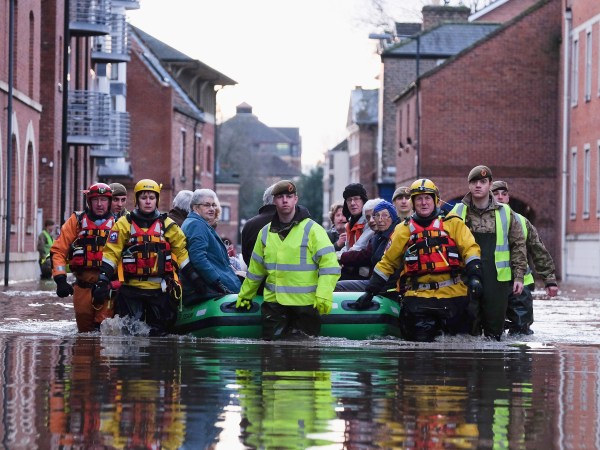 YORK, ENGLAND - DECEMBER 27: Members of Cleveland Mountain Rescue and soldiers from 2 Battalion The Duke of Lancasters Regiment assist members of the public as they are evacuated from the Queens Hotel in York city centre as the River Ouse floods on December 27, 2015 in York, England. Heavy rain over the Christmas period has caused severe flooding in parts of northern England, with homes and businesses in Yorkshire and Lancashire evacuated as water levels continue to rise in many parts. (Photo by Ian Forsyth/Getty Images)