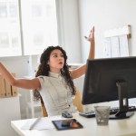 Businesswoman frustrated at computer at desk in office