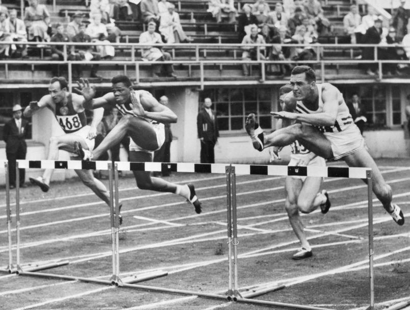 Milton Campbell (second from the left) is shown at the finish of the Decathlon 100-meter hurdles event at the 1952 Olympics. Campbell won the Gold in the event. Helsinki, Finland, 1954. PhotoQuest/ Getty Images.