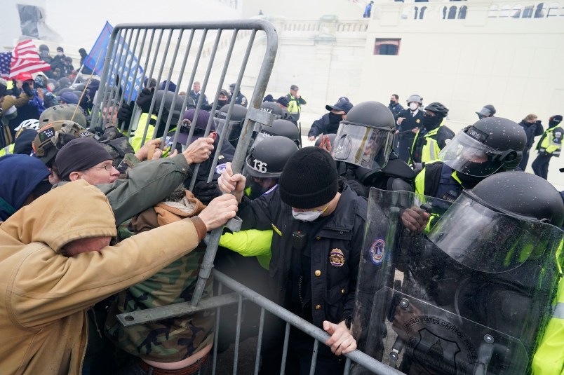 WASHINGTON, DC - JANUARY 06:  Police try to hold back protesters who  gather storm the Capitol and halt a joint session of the 117th Congress on Wednesday, Jan. 6, 2021 in Washington, DC. (Kent Nishimura / Los Angeles Times)