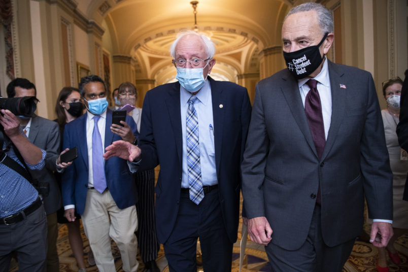 UNITED STATES - AUGUST 9: Senate Majority Leader Charles Schumer, D-N.Y., right, and Sen. Bernie Sanders, I-Vt., are seen in the U.S. Capitol on Monday, August 9, 2021. (Photo By Tom Williams/CQ Roll Call)