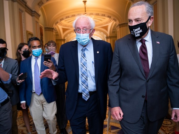 UNITED STATES - AUGUST 9: Senate Majority Leader Charles Schumer, D-N.Y., right, and Sen. Bernie Sanders, I-Vt., are seen in the U.S. Capitol on Monday, August 9, 2021. (Photo By Tom Williams/CQ Roll Call)