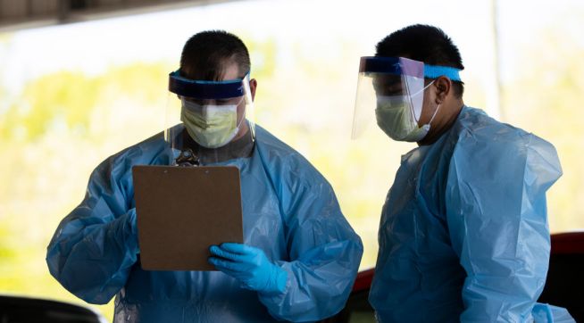 SPRINGFIELD, TN - APRIL 18:  Medical personnel work at a drive thru coronavirus (covid-19) testing site at Robertson County Fairgrounds on April 18, 2020 in Springfield, Tennessee. Tennessee drive thru testing sites now allow those without symptoms of coronavirus (covid-19) to receive testing. (Photo by Brett Carlsen/Getty Images)
