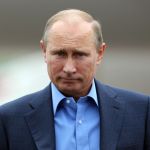 Russian President Vladimir Putin arrives at Belfast International airport in Belfast, Northern Ireland, on June 17, 2013, to attend the G8 summit at the Lough Erne resort. US President Barack Obama was to meet Putin for potentially vexatious talks, as both leaders now offer open military backing to rival sides in Syria's civil war. AFP PHOTO/ PETER MUHLY