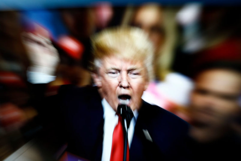 A slow shutter speed image of former US president Donald Trump on a TV screen is seen in this photo illustration in Warsaw, Poland on 23 February, 2022. (Photo by STR/NurPhoto)
