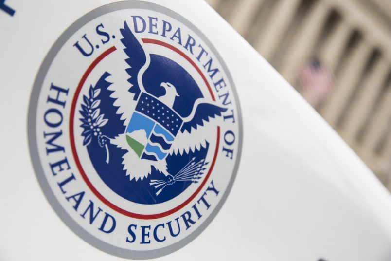 U.S. Department of Homeland Security logo on a white law enforcement vehicle.