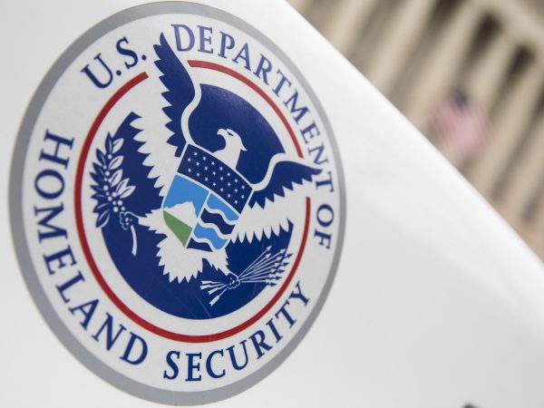 U.S. Department of Homeland Security logo on a white law enforcement vehicle.