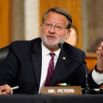 Senator Gary Peters, a Democrat from Michigan, speaking before a mic at a congressional hearing.