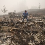 Marcelino Maceda looks for items in the remains of his mobile home after a wildfire sweep through the R.V. park destroying multiple homes in Estacada, Oregon September 12, 2020. US officials girded today for the possibility of mass fatalities from raging wildfires up and down the West Coast, as evacuees recounted the pain of leaving everything behind in the face of fast-moving flames. Dense smog from US wildfires that have burnt nearly five million acres and killed 27 people smothered the West Coast on September 12. (Photo by Robyn Beck / AFP) (Photo by ROBYN BECK/AFP via Getty Images)