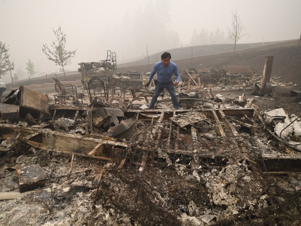 Marcelino Maceda looks for items in the remains of his mobile home after a wildfire sweep through the R.V. park destroying multiple homes in Estacada, Oregon September 12, 2020. US officials girded today for the possibility of mass fatalities from raging wildfires up and down the West Coast, as evacuees recounted the pain of leaving everything behind in the face of fast-moving flames. Dense smog from US wildfires that have burnt nearly five million acres and killed 27 people smothered the West Coast on September 12. (Photo by Robyn Beck / AFP) (Photo by ROBYN BECK/AFP via Getty Images)